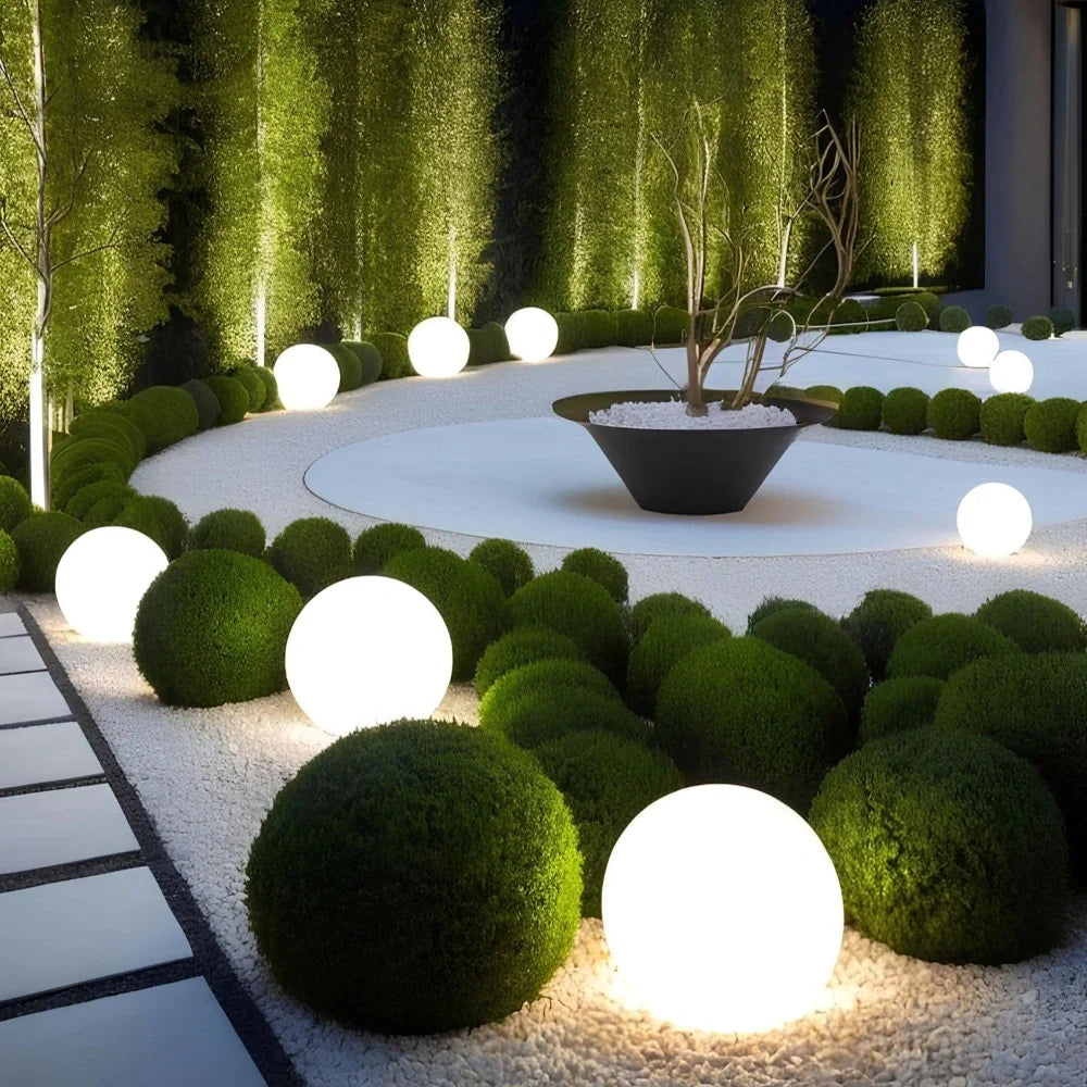 Luna Globe Garden Lights lighting a formal garden after dark