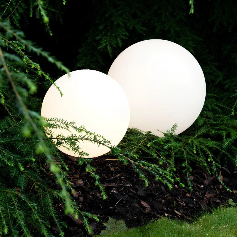 Close view of two globe lights among planting