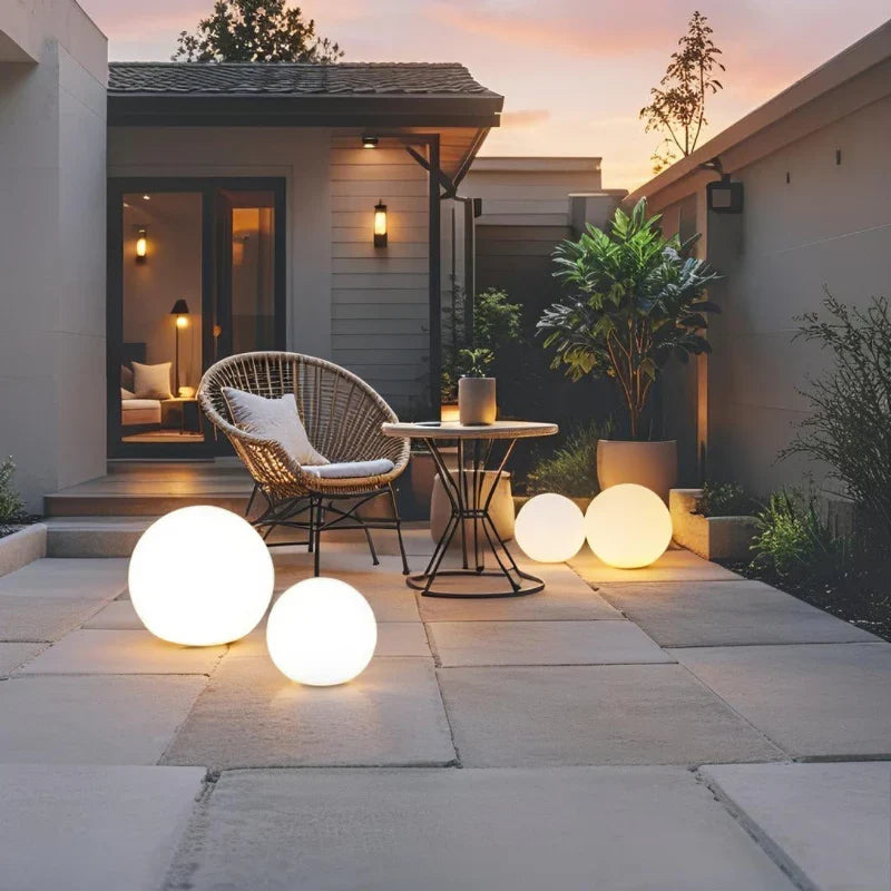 Two globe lights on a terrace at dusk